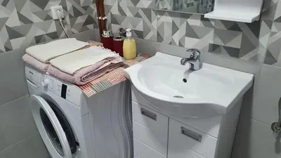 a bathroom with a washing machine and a sink at IMPERIUM stan na dan in Inđija