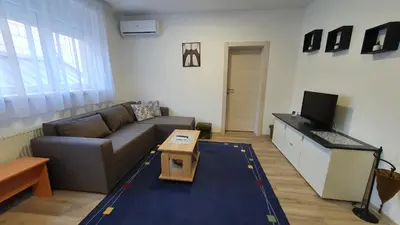 a living room with a couch and a table at IMPERIUM stan na dan in Inđija