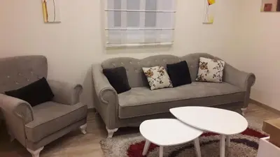 a living room with a couch and a chair and a table at Apartment Dedinje Hill 2 in Belgrade