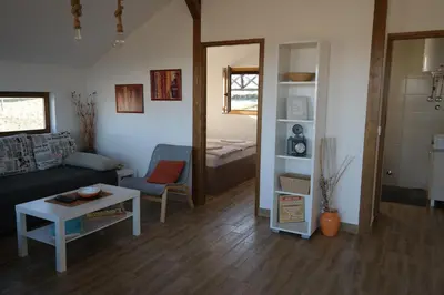 a living room with a couch and a table at LIPA houses & spa in Sopot