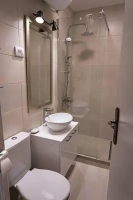 a bathroom with a toilet and a sink and a shower at Classico apartment Belgrade in Voždovac
