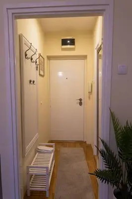 a hallway with a white door and a door sidx sidx sidx at Classico apartment Belgrade in Voždovac