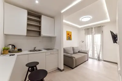 a kitchen and a living room with a couch at Apartmani Statik SD in Smederevo