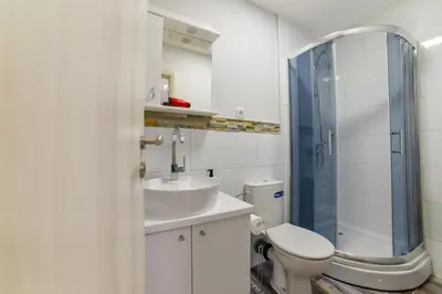 a bathroom with a toilet and a sink and a shower at Apartmani Statik SD in Smederevo