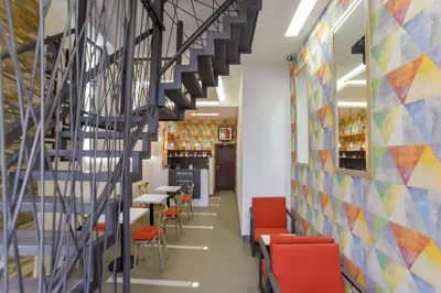 a hallway with stairs and tables and chairs at Apartmani Statik SD in Smederevo