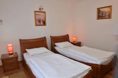 two beds in a room with two lamps on tables at Apartment and Rooms In Club in Inđija