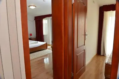 a room with a door and a bedroom with a bed at Apartment and Rooms In Club in Inđija