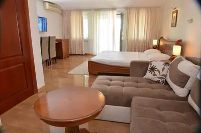 a living room with a couch and a bed at Apartment and Rooms In Club in Inđija