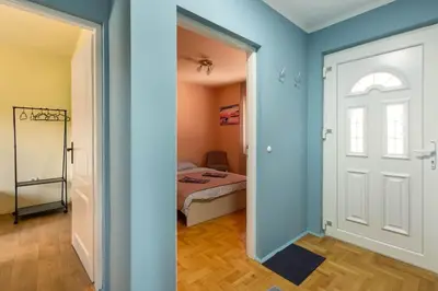 a room with a door and a bedroom with a bed at Charlie&Blueberries in Belgrade