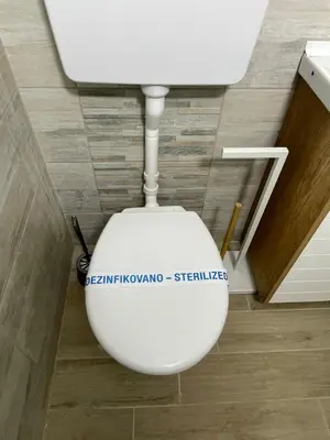 a white toilet with a sticker on it in a bathroom at Charlie&Blueberries in Belgrade