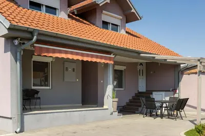 a house with chairs and a table in front of it at Charlie&Blueberries in Belgrade