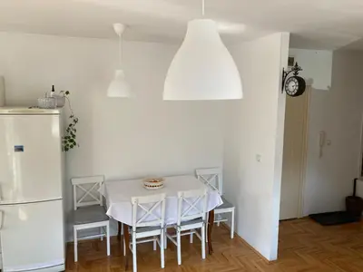 a white dining room with a white table and chairs at Stari Cerak in Žarkovo