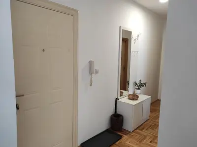 a white bathroom with a white door and a mirror at Stari Cerak in Žarkovo