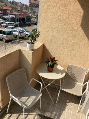 a patio with two chairs and a table on a balcony at Stari Cerak in Žarkovo