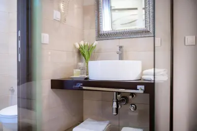 a bathroom with a sink and a mirror at Luka de Luka Suites in Belgrade