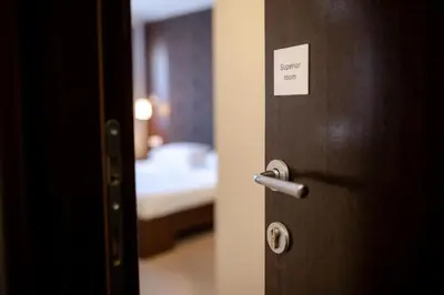 a door to a bedroom with a bed in a room at Luka de Luka Suites in Belgrade