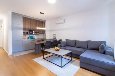 a living room with a couch and a table at Apartment Garden in Belgrade