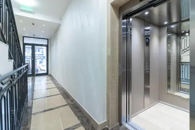 a hallway of a building with glass doors at Apartment Garden in Belgrade