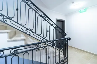 a stairway with a black metal railing at Apartment Garden in Belgrade