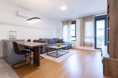a living room with a table and a couch at Apartment Garden in Belgrade