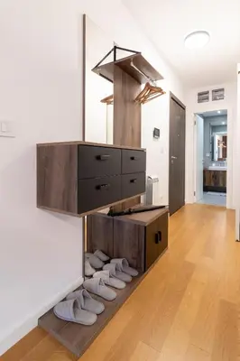 a room with a dresser and shoes on the floor at Apartment Garden in Belgrade