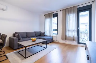 a living room with a couch and a table at Apartment Garden in Belgrade