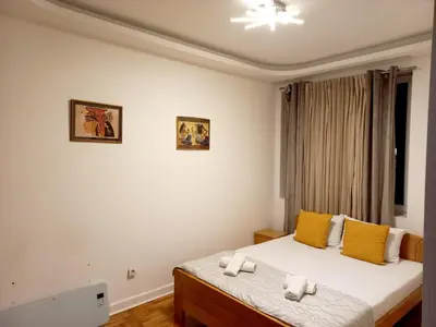 a bedroom with a bed with towels on it at Apartment Alex in Belgrade
