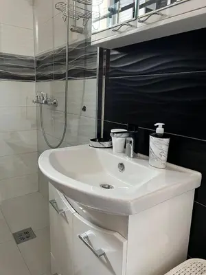 a white bathroom with a sink and a shower at Apartment Alex in Belgrade