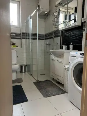 a bathroom with a toilet sink and a washing machine at Apartment Alex in Belgrade