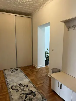 an empty living room with a table and a rug at Apartment Alex in Belgrade
