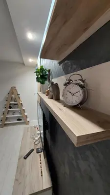 a clock sitting on a shelf in a room at Apartman 23 in Belgrade