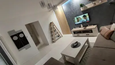 a living room with a couch and a table at Apartman 23 in Belgrade