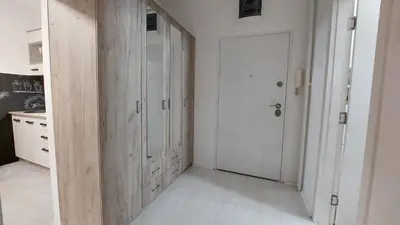 a hallway with white walls and a white door at Apartman 23 in Belgrade