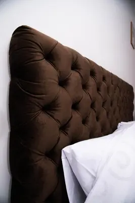 a brown tufted headboard of a bed in a bedroom at Sobe i Apartmani Casa Mia in Pećinci