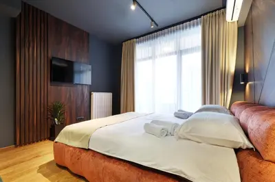 a bedroom with a large bed and a large window at Belgrade Waterfront Apartments - Arcadia in Belgrade