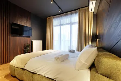 a bedroom with a large bed with two towels on it at Belgrade Waterfront Apartments - Arcadia in Belgrade