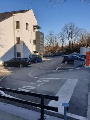 a parking lot with cars parked in a building at Apartman Magija in Arandjelovac