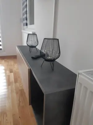 two black chairs sitting on top of a black table at Apartman Magija in Arandjelovac