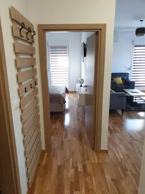 a room with a staircase and a living room with a couch at Apartman Magija in Arandjelovac