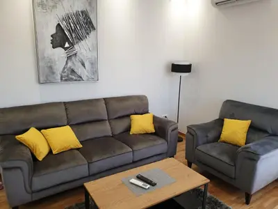 a living room with a couch and a coffee table at Apartman Magija in Arandjelovac