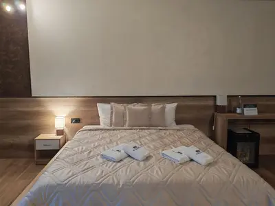 a bedroom with a bed with two towels on it at Monogramlux in Inđija