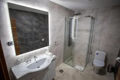 a bathroom with a shower and a sink and a toilet at Monogramlux in Inđija