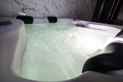 a bath tub filled with green water at Monogramlux in Inđija