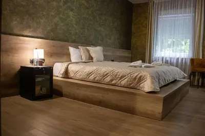a bedroom with a large bed in a room at Monogramlux in Inđija