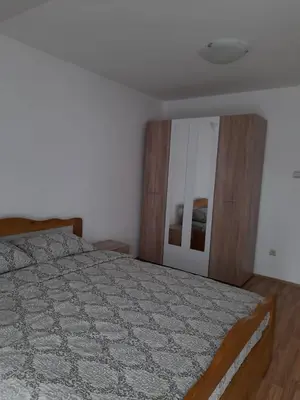 a bedroom with a bed and a mirror at Apartman Giovanni in Arandjelovac