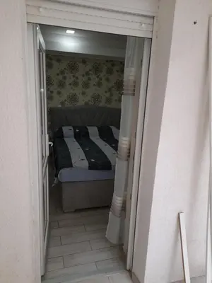 a small bedroom with a bed in a hallway at Daca 1 in Belgrade