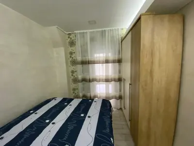 a bedroom with a bed and a closet and a window at Daca 1 in Belgrade