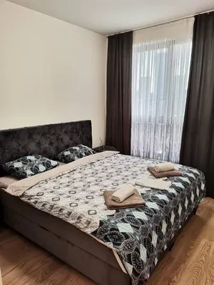 a bedroom with a bed with two towels on it at Aurora BW in Belgrade