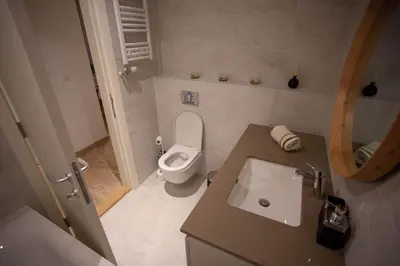 a small bathroom with a toilet and a sink at Aurora BW in Belgrade