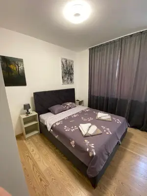 a bedroom with a bed with a purple comforter at Aurora BW in Belgrade